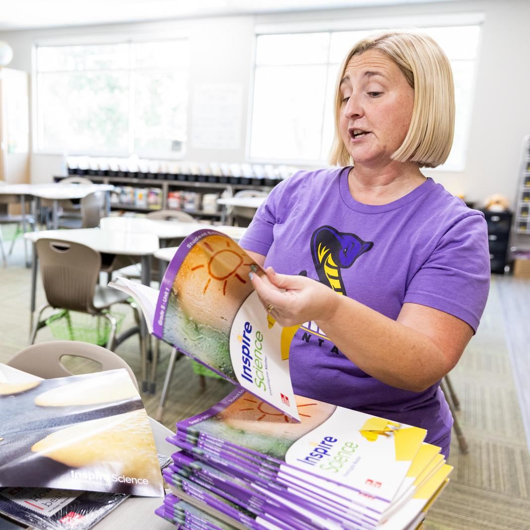 A teacher reviews new materials 